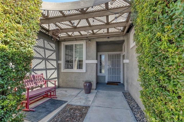 44620 Painted Desert St, Lancaster, CA 93536 - property entrance with a pergola, a patio area, and stucco siding
