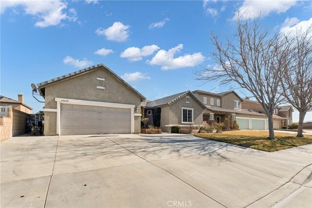 44620 Painted Desert St, Lancaster, CA 93536 - view of front of property featuring an attached garage, concrete driveway, and stucco siding