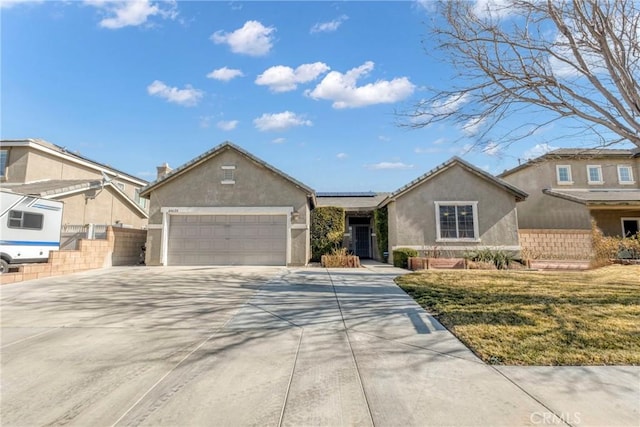 44620 Painted Desert St, Lancaster, CA 93536 - view of front of property featuring stucco siding, driveway, an attached garage, fence, and roof mounted solar panels