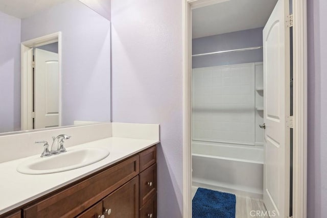 bathroom featuring vanity and  shower combination