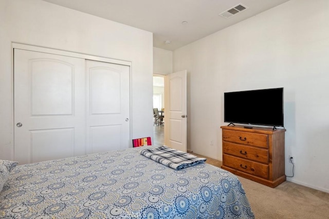 carpeted bedroom featuring a closet