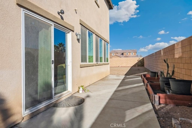 view of side of home featuring a patio