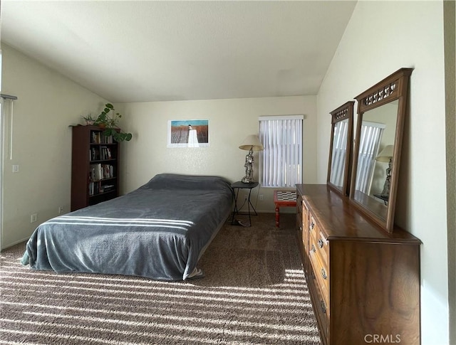 bedroom featuring dark colored carpet, baseboards, and lofted ceiling