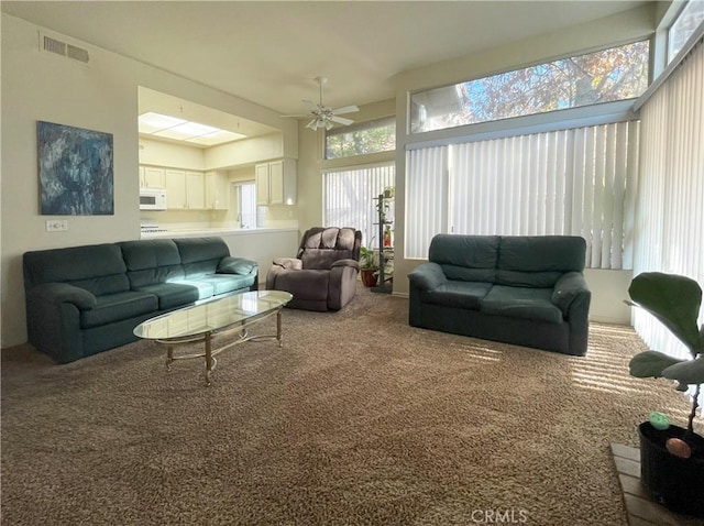 sunroom featuring ceiling fan