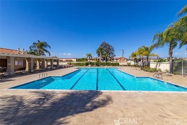 community pool featuring a patio and fence