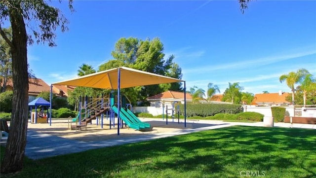 community playground featuring a lawn