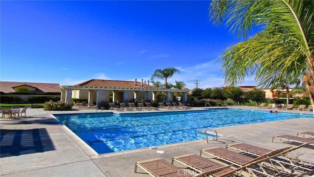 community pool with a patio area