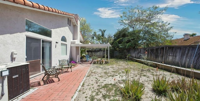 view of yard featuring central AC unit, a fenced backyard, and a patio area