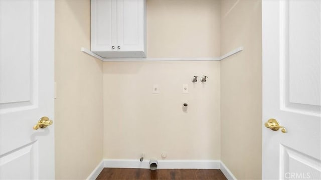 laundry area with electric dryer hookup, hookup for a gas dryer, dark hardwood / wood-style flooring, washer hookup, and cabinets