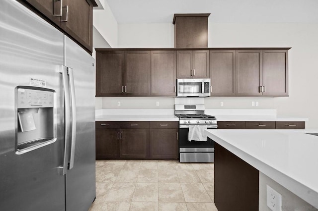 kitchen with light tile patterned floors, dark brown cabinetry, and appliances with stainless steel finishes