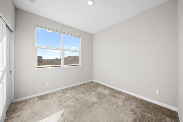 interior space with a closet and light colored carpet