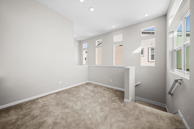 empty room with a wealth of natural light and light carpet