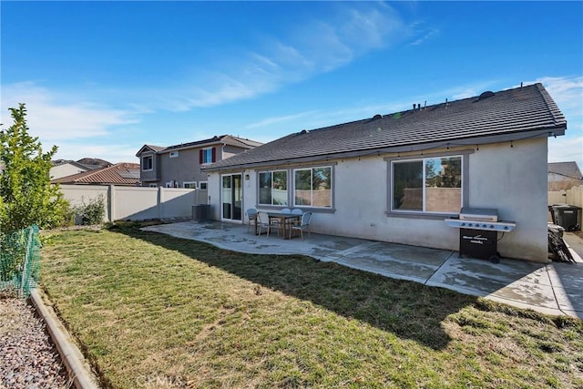 back of house featuring a patio area and a yard