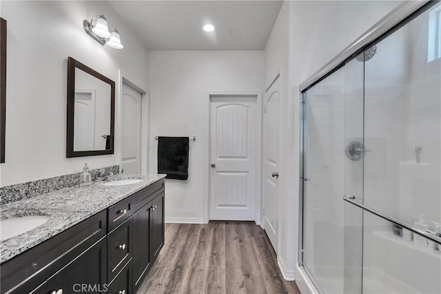 bathroom featuring vanity, a shower with door, and hardwood / wood-style floors