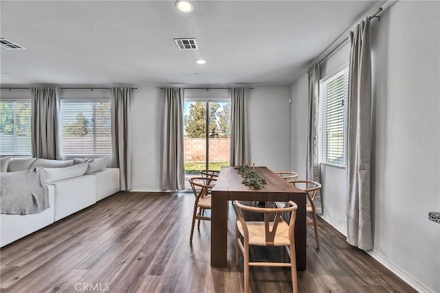 dining room featuring dark wood-type flooring and plenty of natural light