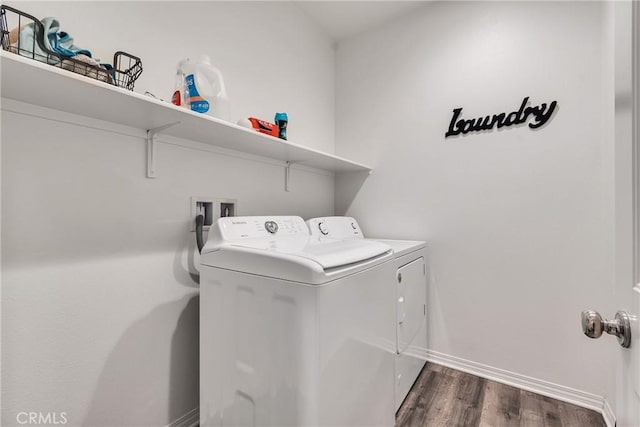 clothes washing area featuring dark hardwood / wood-style flooring and independent washer and dryer