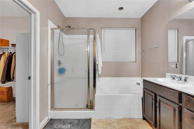 bathroom featuring vanity and independent shower and bath