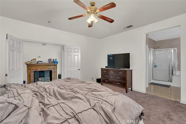 carpeted bedroom with a fireplace, ceiling fan, and connected bathroom