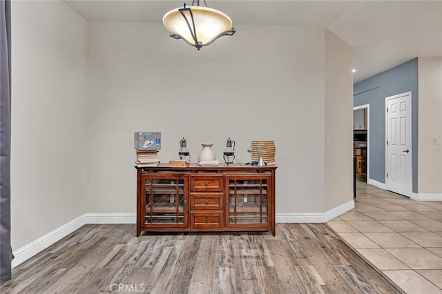 bar with pendant lighting and hardwood / wood-style flooring