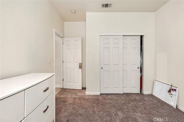 unfurnished bedroom with a closet and carpet flooring