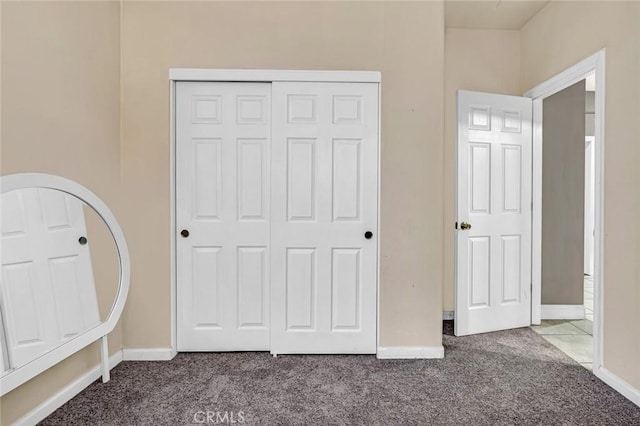 unfurnished bedroom featuring a closet and carpet flooring