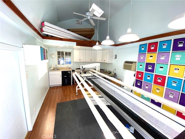 kitchen featuring dark wood-type flooring, sink, pendant lighting, and white cabinets