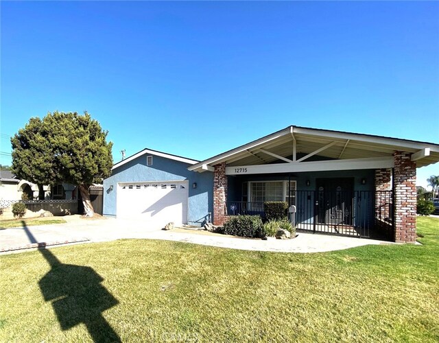 single story home featuring a front lawn, a garage, and a porch