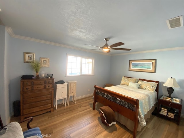 bedroom with ceiling fan, a textured ceiling, hardwood / wood-style flooring, and crown molding