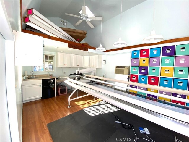 kitchen featuring ceiling fan, dark hardwood / wood-style flooring, high vaulted ceiling, pendant lighting, and white cabinets