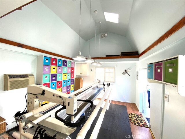 interior space featuring high vaulted ceiling, wood-type flooring, and a wall unit AC