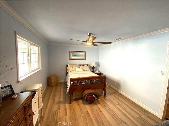 bedroom with ceiling fan, light hardwood / wood-style floors, and crown molding