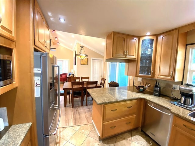 kitchen featuring pendant lighting, lofted ceiling, stainless steel appliances, kitchen peninsula, and light tile patterned floors