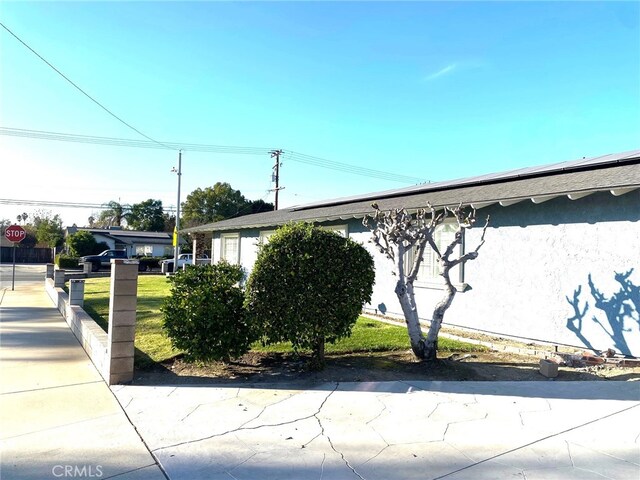 view of property exterior with a yard