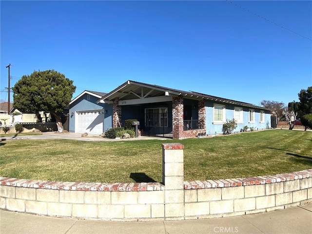 view of front of property with a garage and a front lawn