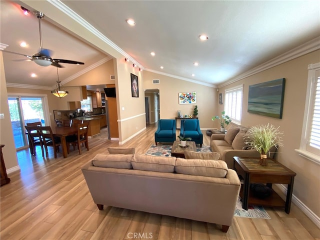 living room featuring crown molding, lofted ceiling, light hardwood / wood-style flooring, and ceiling fan