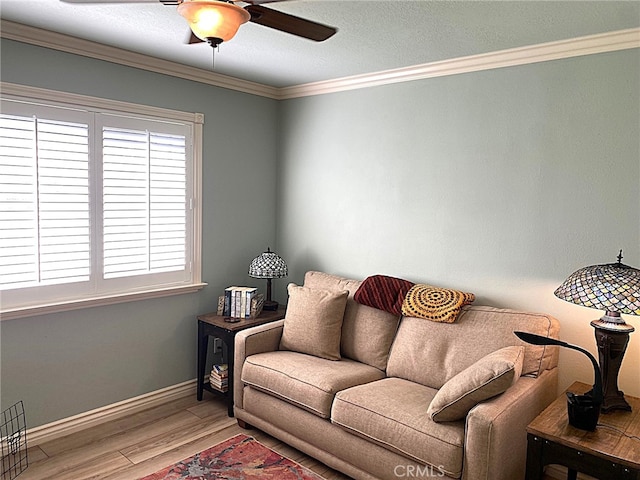 living room with ceiling fan, crown molding, and hardwood / wood-style flooring