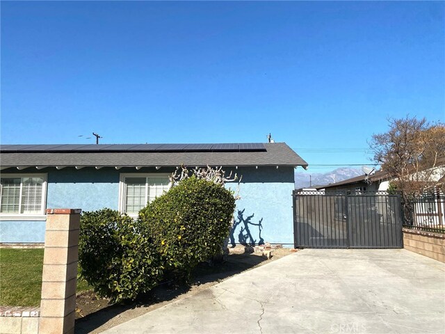 view of side of home featuring solar panels