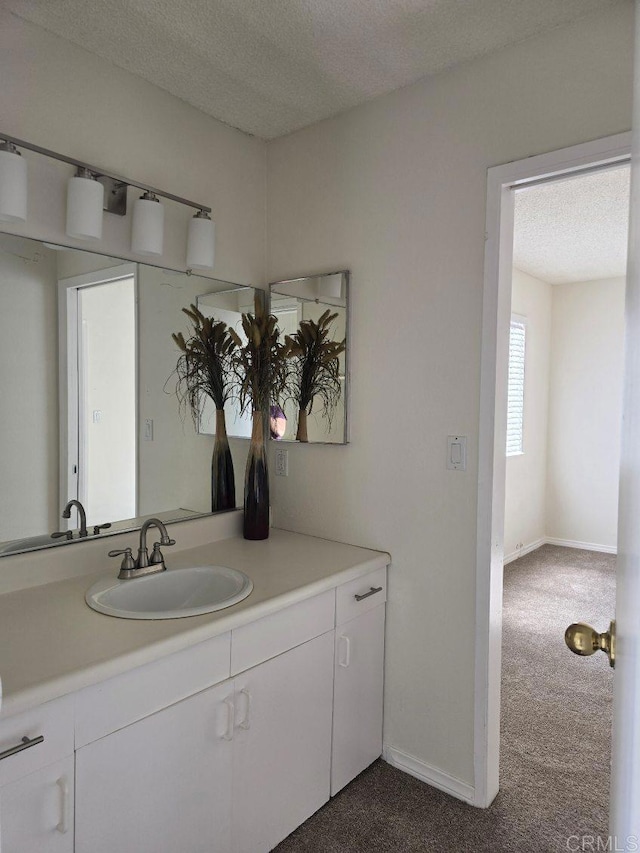 bathroom with a textured ceiling and vanity