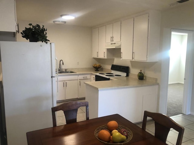 kitchen featuring light tile patterned floors, kitchen peninsula, white appliances, white cabinets, and sink