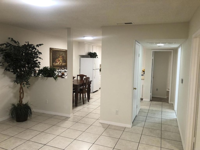 corridor featuring light tile patterned flooring