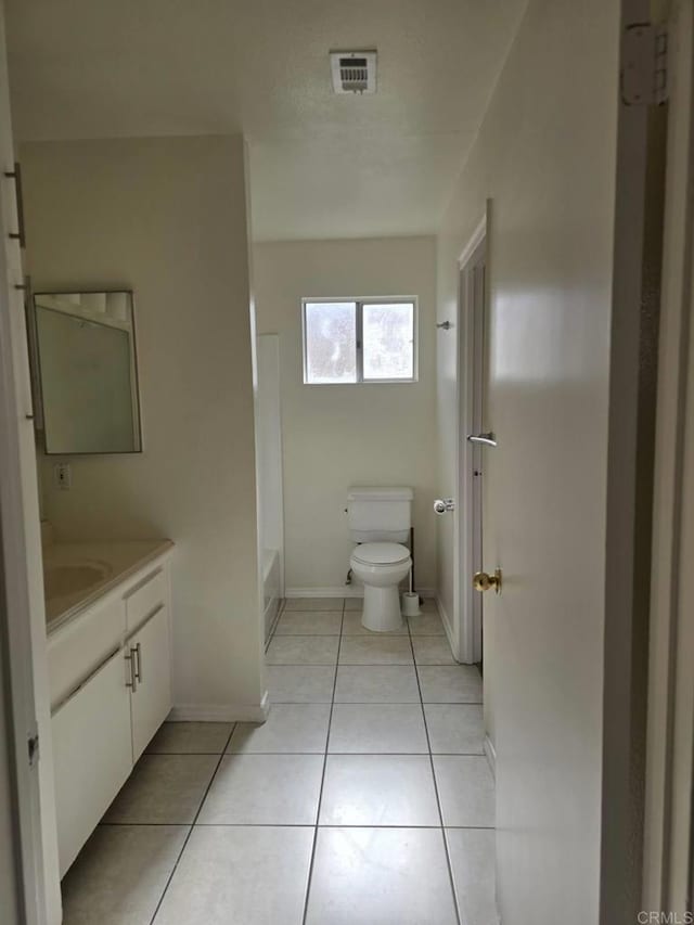 bathroom featuring tile patterned floors, toilet, and vanity