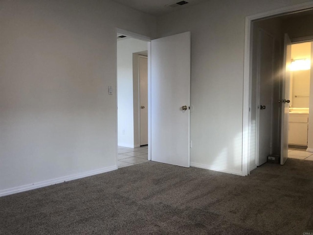 unfurnished bedroom featuring light carpet