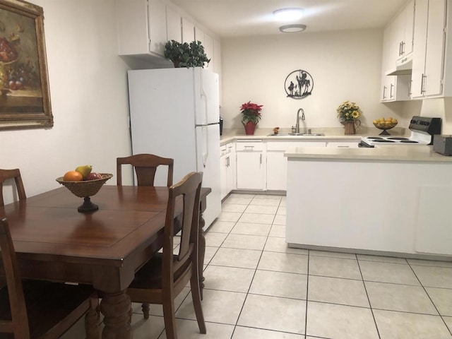 kitchen featuring white cabinetry, white refrigerator, electric stove, sink, and light tile patterned floors