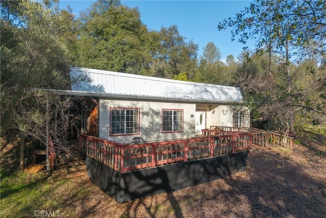 back of house featuring a deck