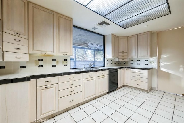 kitchen featuring tasteful backsplash, dishwasher, tile countertops, sink, and light tile patterned flooring