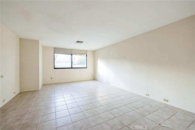 spare room featuring light tile patterned floors