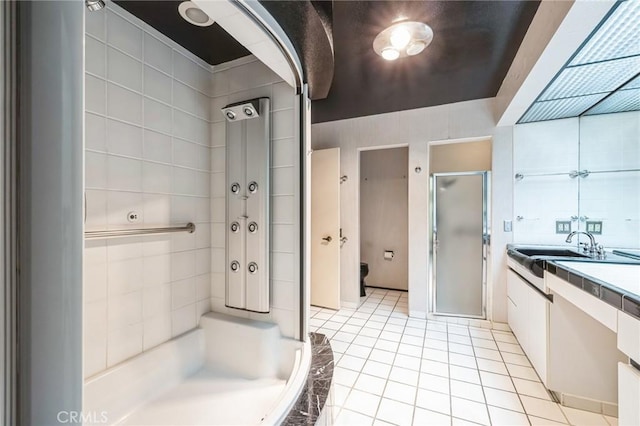 bathroom with vanity, independent shower and bath, and tile patterned floors