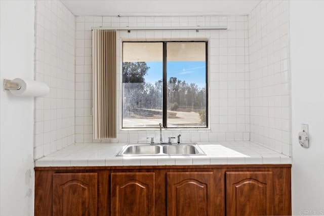 kitchen with brown cabinetry and a sink