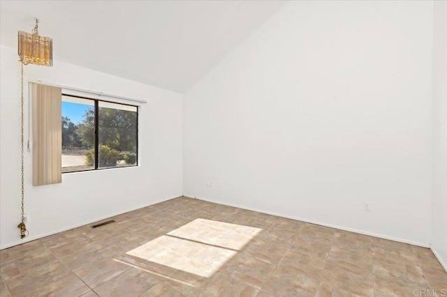 unfurnished room with lofted ceiling and visible vents