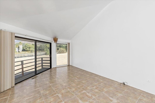 empty room with lofted ceiling and visible vents